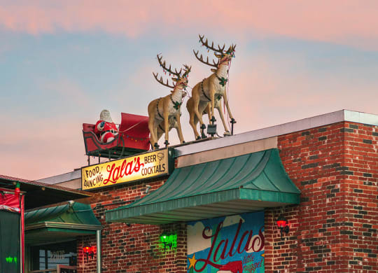 a building with a statue of deer on top of it