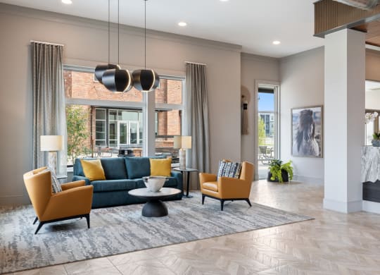 a living room with a blue couch and two yellow chairs