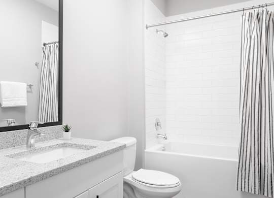 A white bathroom with a sink, toilet, and bathtub.