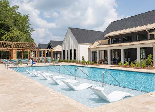 A large swimming pool with a white diving board.