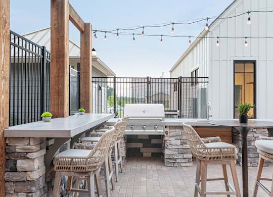 A patio with a table and chairs is set up outside a house.
