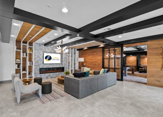 a lobby with a couch and chairs and a fireplace