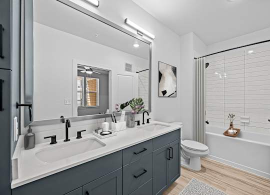 A modern bathroom with a white sink and a white toilet.