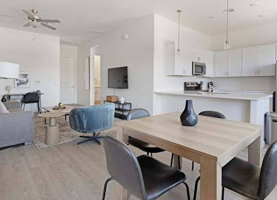 A modern dining room with a wooden table and chairs.