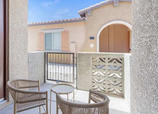 A patio with a table and chairs is shown.