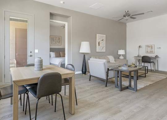 A living room with a dining table and chairs.