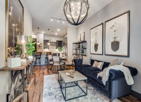 a living room filled with furniture and a large chandelier