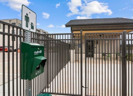 a metal fence with a green parking lot