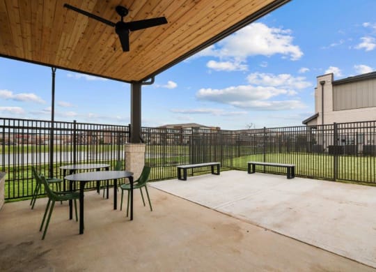 the spacious patio of our apartments with tables and chairs