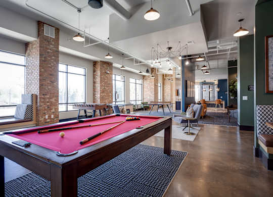 a pool table in the resident clubhouse at the bradley braddock road station apartments