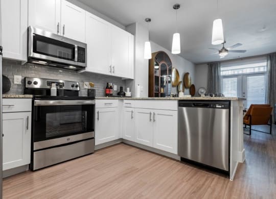 a kitchen with stainless steel appliances and white cabinets