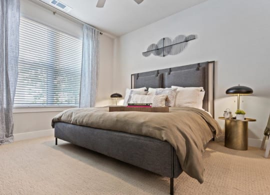 a bedroom with a bed and a large window