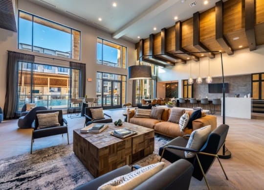 a large living room with couches and chairs and a table