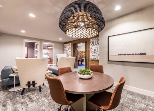 a dining room with a table and chairs and a large chandelier