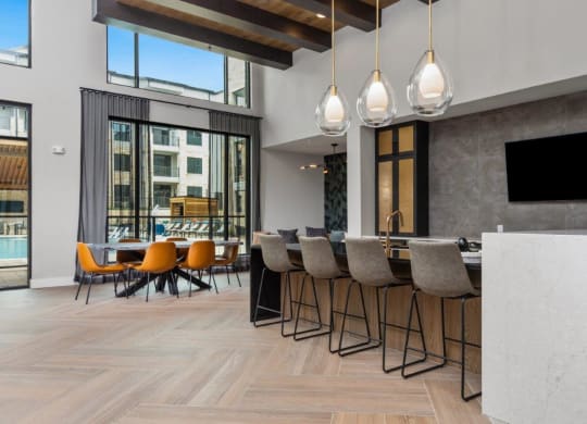 a bar and dining area in a room with large windows