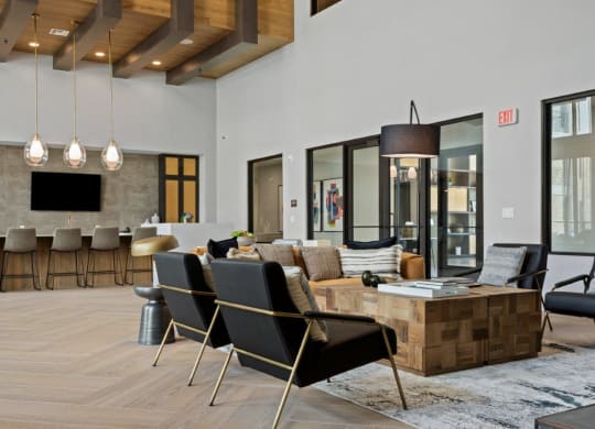 a living room with a couch and chairs and a table