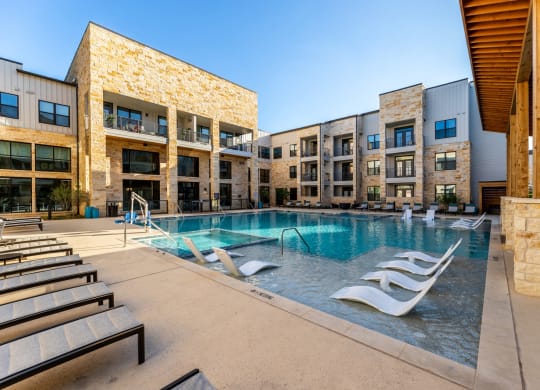 Maddox Hills Exterior and Pool with Lounge Chairs