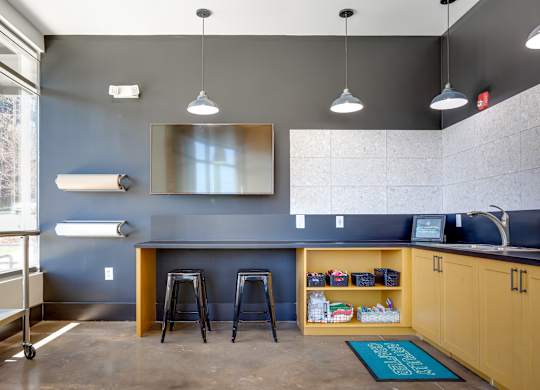 a kitchenette with a bar and stools