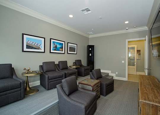 A living room with grey couches and a television.