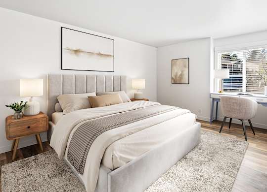 A bedroom with a large bed, a desk with a chair, and a window with blinds.