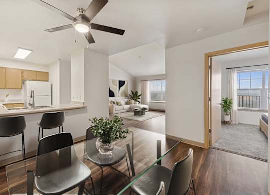 A modern kitchen with a dining table and chairs.