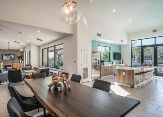 a dining room table with a view of a kitchen and living room in the background