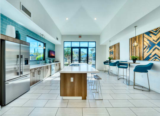 a kitchen with a large center island next to a stove top oven
