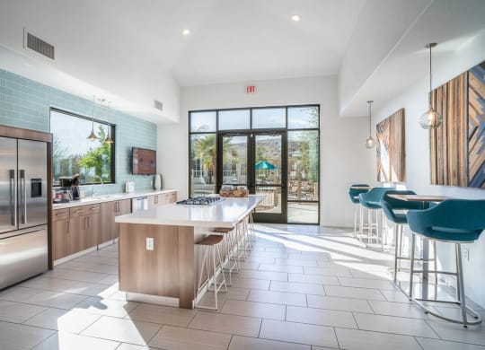 a kitchen with a large center island next to a doorway
