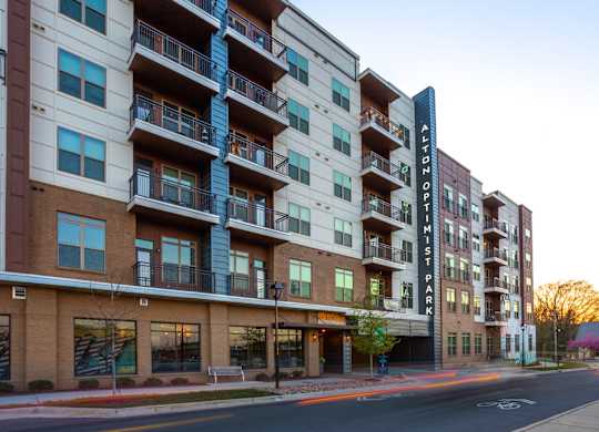 picture of an apartment building with a street in front of it