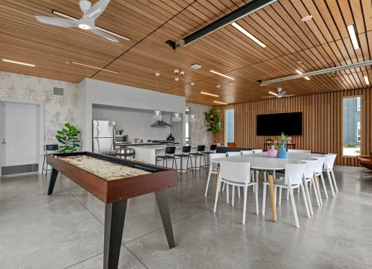 a game room with a pool table and a dining table