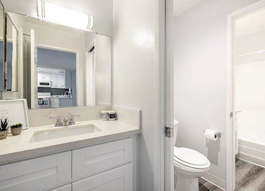 A white bathroom with a toilet and sink.