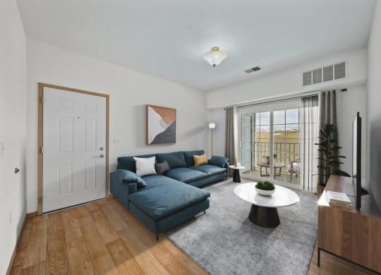 a living room with a blue couch and a white coffee table