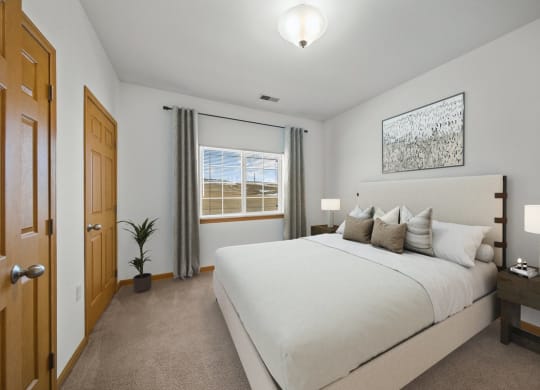 a bedroom with a large bed and a window