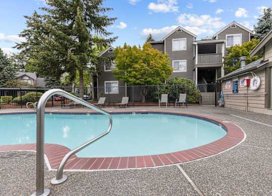 a swimming pool with an apartment building in the background