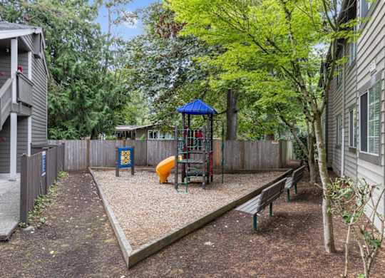 a play yard with a swing set and a playground