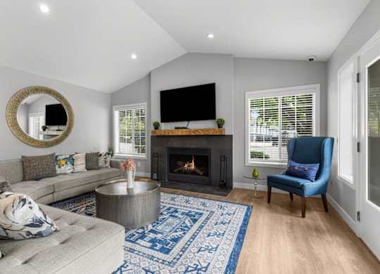 a living room with a couch and a chair and a fireplace