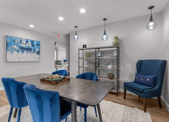 a dining room with blue chairs and a table