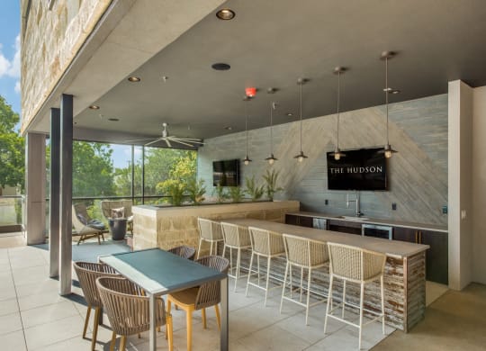 a bar with chairs and a table in front of a window