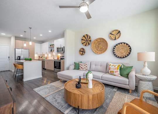 A modern living room with a grey couch and wooden coffee table.