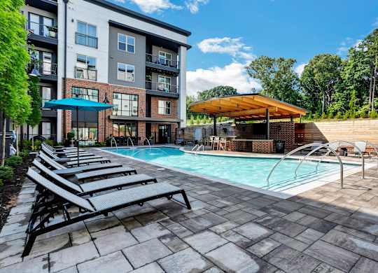 Skye Suwanee Town Center Apartments in Suwanee, Georgia Pool with Lounge Chairs
