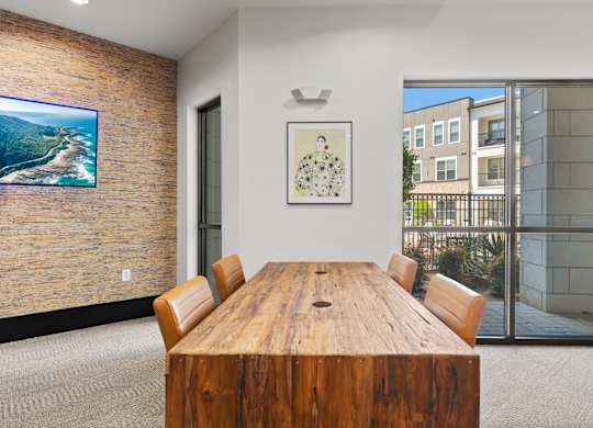 A conference room with a wooden table and chairs.