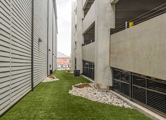 A concrete building with a green lawn in front.