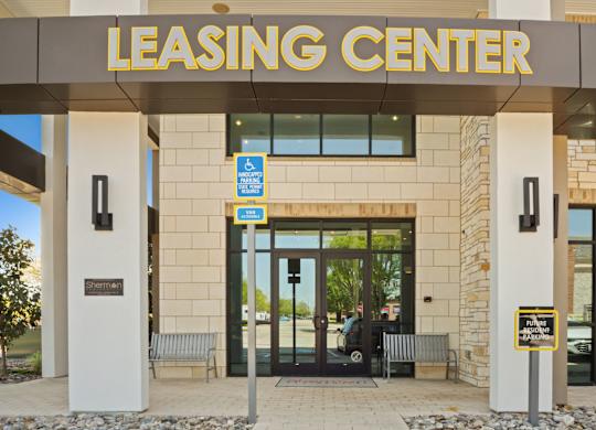 The leasing center has a parking sign on the wall.