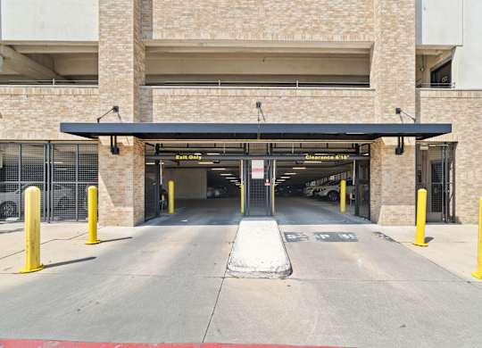 A parking garage entrance with a sign that says "Entrance 1".