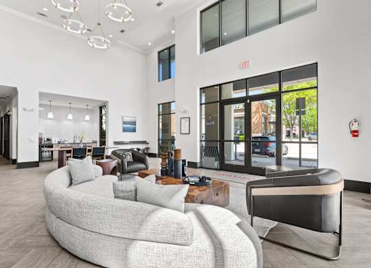 A modern living room with a curved sofa and a fireplace.