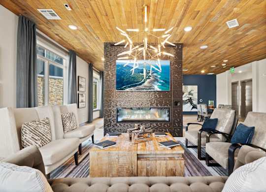 A modern living room with a fireplace and a large painting above it.