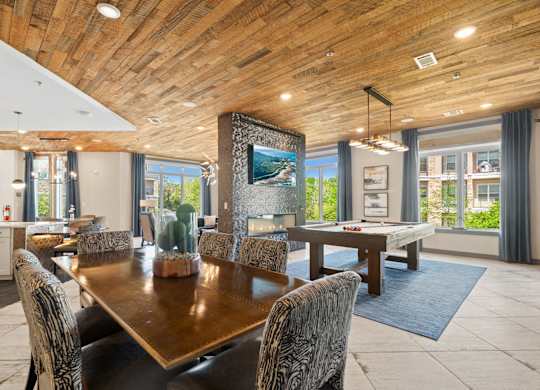 A modern dining room with a wooden table and chairs.