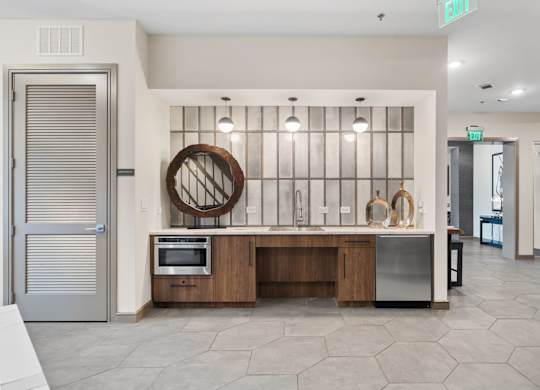 A modern kitchen with a wooden island and stainless steel appliances.