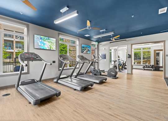 A gym with treadmills and exercise equipment.