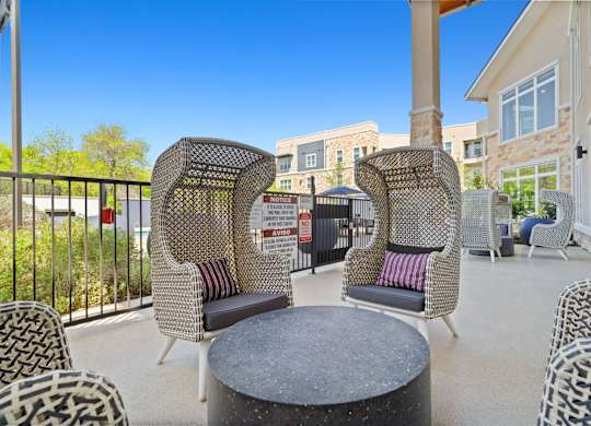 A patio with a table and chairs.